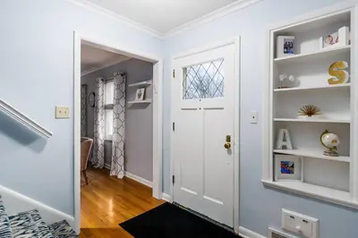 a hallway with a white door and white shelves at Bexley Family Friendly ★ King Bed ★ Staycation in Columbus