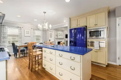 a kitchen with a blue counter top and a dining room at Bexley Family Friendly ★ King Bed ★ Staycation in Columbus
