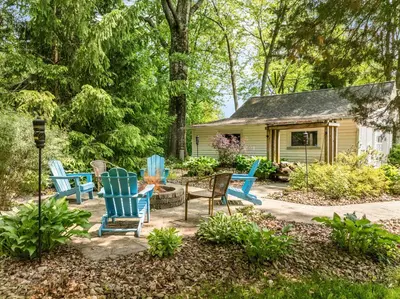 a group of chairs sitting in a yard at Blissful Serenity - Walk to Lake Milton with Hot Tub in Lake Milton