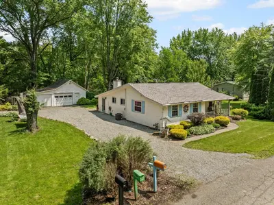 a home with a driveway and a house at Blissful Serenity - Walk to Lake Milton with Hot Tub in Lake Milton