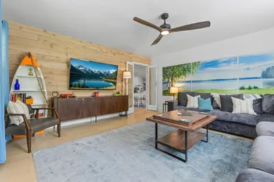 a living room with a couch and a table at Blissful Serenity - Walk to Lake Milton with Hot Tub in Lake Milton