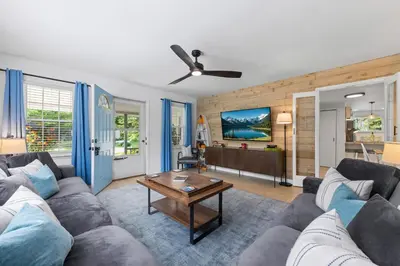 a living room with a couch and a table at Blissful Serenity - Walk to Lake Milton with Hot Tub in Lake Milton