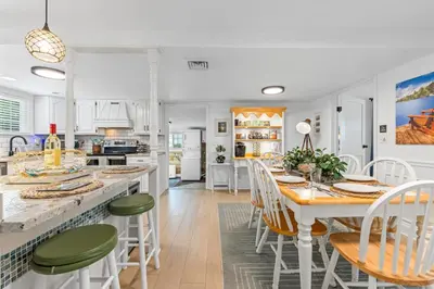 a kitchen and dining room with a table and chairs at Blissful Serenity - Walk to Lake Milton with Hot Tub in Lake Milton