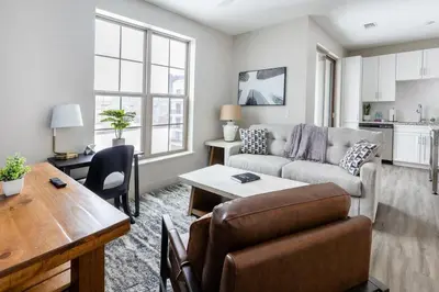 a living room with a couch and a table at Landing Stylish 1BD Gym Courtyard in Cleveland