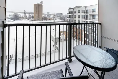 a balcony with a table and chairs and a window at Landing Stylish 1BD Gym Courtyard in Cleveland