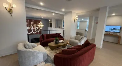 a living room with couches and a flat screen tv at Landing Stylish 1BD Gym Courtyard in Cleveland