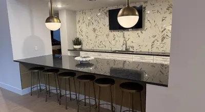 a kitchen with a black counter and stools at Landing Stylish 1BD Gym Courtyard in Cleveland