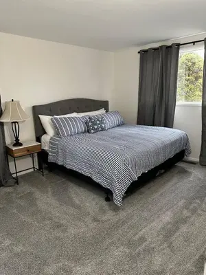 a bedroom with a bed and a window at Charming Mentor Home w/ Fenced Backyard in Mentor