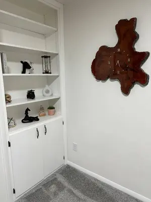 a room with white shelves with figurines on them at Charming Mentor Home w/ Fenced Backyard in Mentor