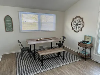 a dining room with a table and a bench at Charming Mentor Home w/ Fenced Backyard in Mentor