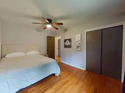 a bedroom with a bed and a ceiling fan at Rustic Kirtland Farmhouse Retreat in Kirtland