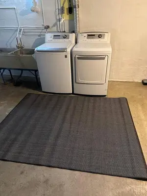 two appliances sitting on a rug in a garage at Rustic Kirtland Farmhouse Retreat in Kirtland
