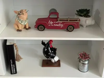 a toy dog and a fire truck on a shelf at Rustic Kirtland Farmhouse Retreat in Kirtland