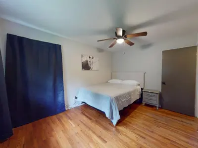 a bedroom with a bed and a ceiling fan at Rustic Kirtland Farmhouse Retreat in Kirtland