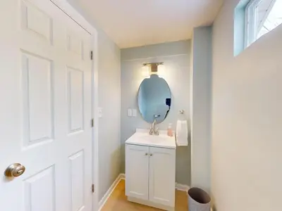 a bathroom with a white sink and a mirror at Stylish Home Near Historic Downtown & Lake Erie in Willoughby