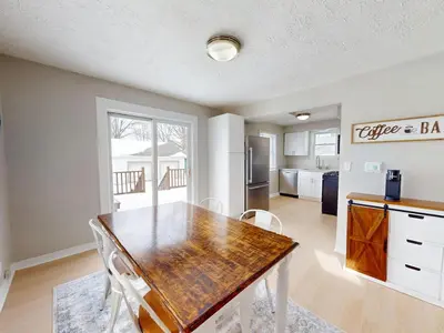 a kitchen and dining room with a table and chairs at Stylish Home Near Historic Downtown & Lake Erie in Willoughby