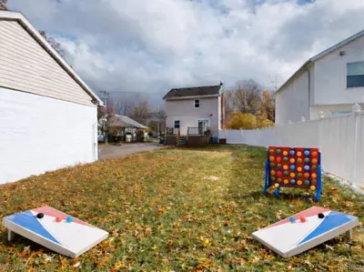 a yard with two ping pong tables on the grass at Stylish Home Near Historic Downtown & Lake Erie in Willoughby