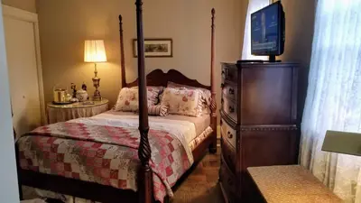 a bedroom with a bed and a tv on a dresser at Clifford House Private Home B&B in Cleveland