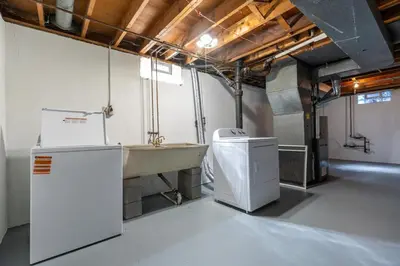 a bathroom with a sink and a washer at Akron 2 Bed 1 Bath Mountain Oasis Dog Friendly in Akron