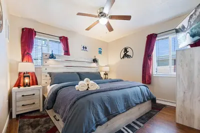 a bedroom with a bed and a ceiling fan at Akron 2 Bed 1 Bath Mountain Oasis Dog Friendly in Akron