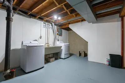 a laundry room with two washing machines and a sink at Akron 2 Bed 1 Bath Flight Themed Oasis Dog Friendly in Akron