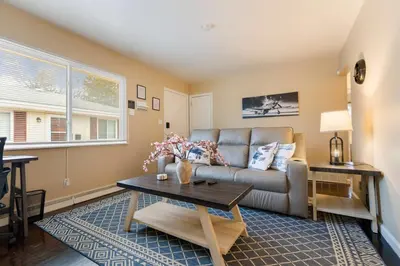 a living room with a couch and a table at Akron 2 Bed 1 Bath Flight Themed Oasis Dog Friendly in Akron