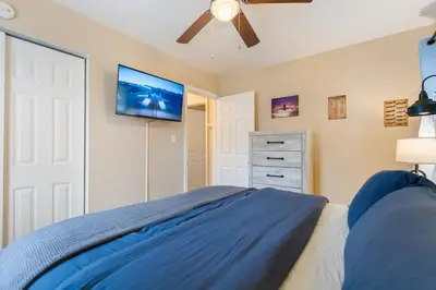 a bedroom with a bed and a flat screen tv at Akron 2 Bed 1 Bath Flight Themed Oasis Dog Friendly in Akron
