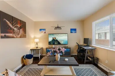 a living room with a table and a desk at Akron 2 Bed 1 Bath Flight Themed Oasis Dog Friendly in Akron