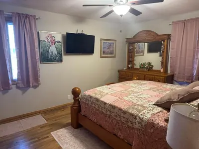 a bedroom with a bed and a ceiling fan at Muncie 3 bedroom 2 bath brick home in Muncie