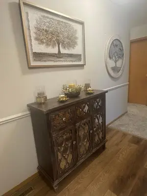 a wooden cabinet in a room with a picture on the wall at Muncie 3 bedroom 2 bath brick home in Muncie