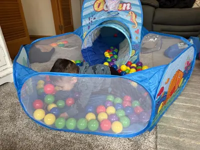 a child swimming in a pool of balls at Muncie 3 bedroom 2 bath brick home in Muncie
