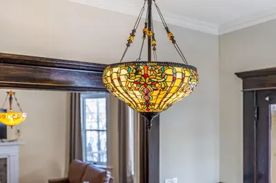 a stained glass chandelier hanging from a ceiling at The Hazelton in Downtown Lancaster's Historic District in Lancaster