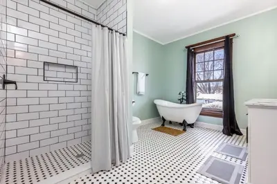 a bathroom with a white tub and a window at The Hazelton in Downtown Lancaster's Historic District in Lancaster