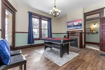 a living room with a pool table and a fireplace at The Hazelton in Downtown Lancaster's Historic District in Lancaster