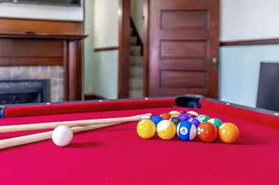 a red pool table with cue balls and cue sticks at The Hazelton in Downtown Lancaster's Historic District in Lancaster