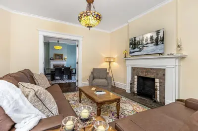 a living room with a couch and a fireplace at The Hazelton in Downtown Lancaster's Historic District in Lancaster