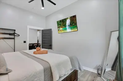 a bedroom with a bed and a picture on the wall at Pine Grove Barndominium in Sugar Grove