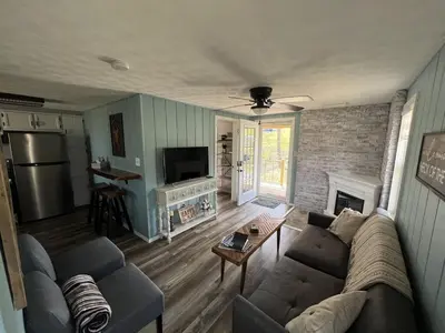 a living room with a couch and a fireplace at Salt Creek Cabin in Chillicothe