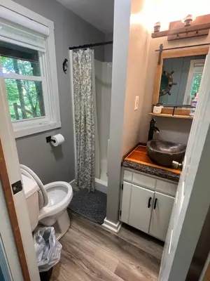 a bathroom with a toilet and a sink at Salt Creek Cabin in Chillicothe