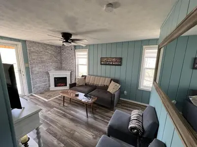 a living room with a couch and a fireplace at Salt Creek Cabin in Chillicothe