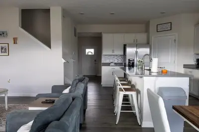 a living room with a couch and a kitchen at Holistic Campus Rental, LLC in Oxford