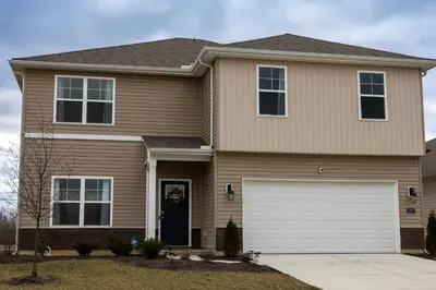 a brown house with a white garage at Holistic Campus Rental, LLC in Oxford