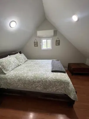 a bedroom with a bed in a attic at Walnut Creek Cabin in Chillicothe