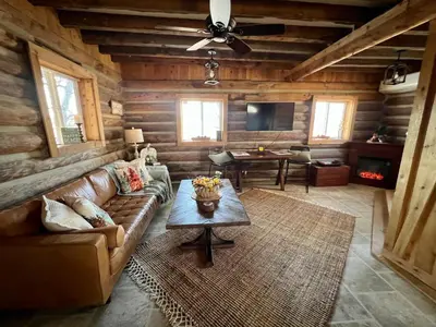 a living room with a couch and a table at Walnut Creek Cabin in Chillicothe