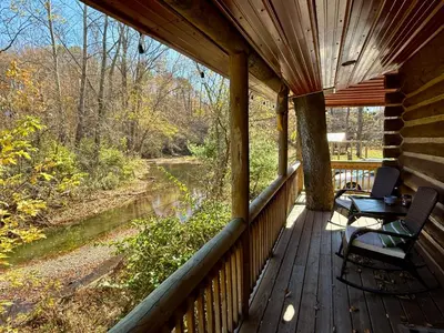 a porch of a cabin with a table and a bench at Walnut Creek Cabin in Chillicothe
