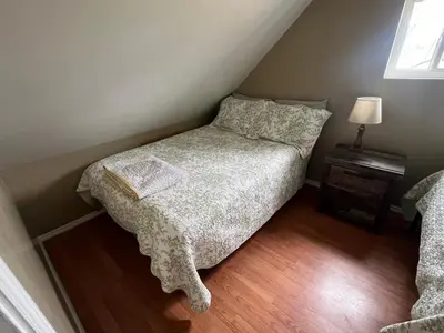a small bedroom with a bed and a lamp at Walnut Creek Cabin in Chillicothe