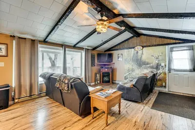 a living room with couches and a ceiling fan at Deck and Fire Pit! Muskingum Fishing Cabin in Dresden