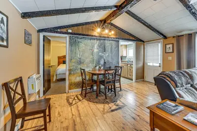 a living room with a table and chairs at Deck and Fire Pit! Muskingum Fishing Cabin in Dresden