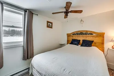 a bedroom with a bed and a window at Deck and Fire Pit! Muskingum Fishing Cabin in Dresden