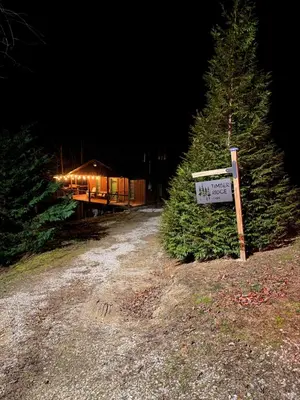 a sign in front of two trees and a cabin at Timber Ridge Cabin in Louisa